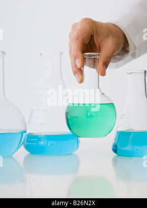 Male scientist holding beaker of liquid Stock Photo