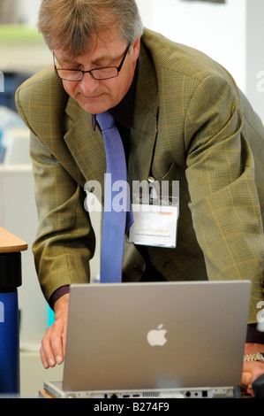 Royalty free photograph of business man using a apple mac laptop at his London offices UK Stock Photo