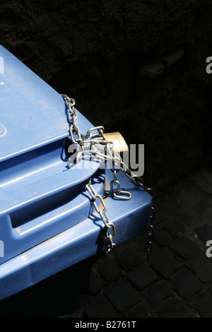 household rubbish bin locked with chain and padlock Stock Photo