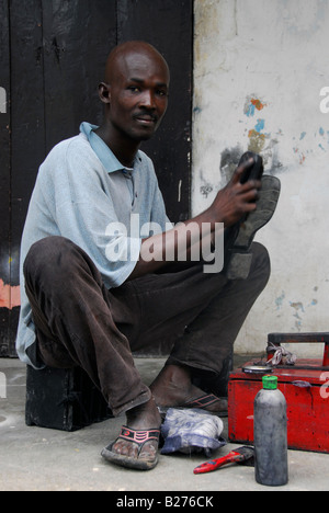Young shoemaker in Jacmel, Haiti Stock Photo