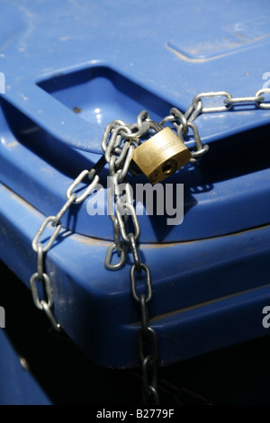 household rubbish bin locked with chain and padlock Stock Photo