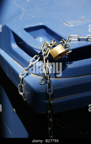 household rubbish bin locked with chain and padlock Stock Photo