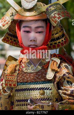 Boy wearing samurai costume participating in the Gion Matsuri Hanagasa Gyoretsu parade during summer in Kyoto Stock Photo