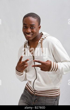 Dark skinned handsome young man stylish wearing a white hooded shirt peace Isolated Stock Photo