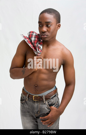 Young dark skinned handsome guy standing like a macho Stock Photo