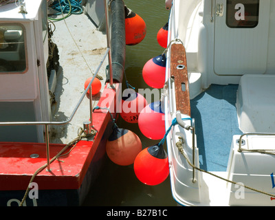 Colourful fenders on side of fishing boat Stock Photo