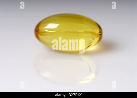 Stock photo of a Vitamin E yellow capsule These capsules are a natural health product derived from Sunflower oil Stock Photo