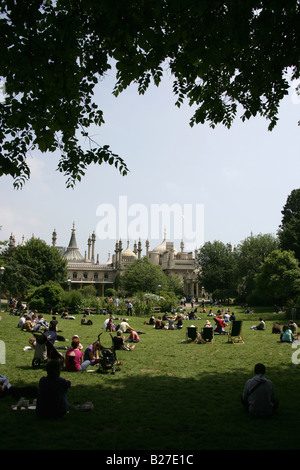 City of Brighton and Hove, England. Visitors, locals enjoying the sun on the lawns with Brighton Pavilion in the background. Stock Photo