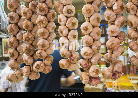 Strings of garlic in market Spain Stock Photo