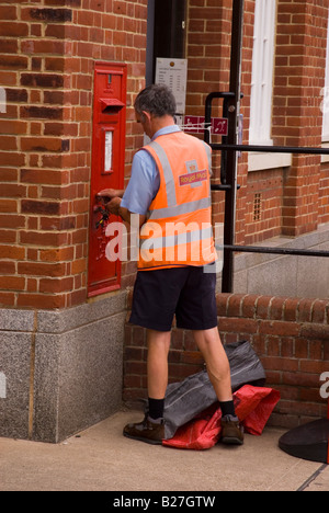 Postman Emptying Postbox At Post Office In Aldeburgh,Suffolk,Uk Stock Photo