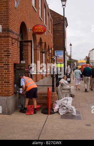 Postman Emptying Postbox At Post Office In Aldeburgh,Suffolk,Uk Stock Photo