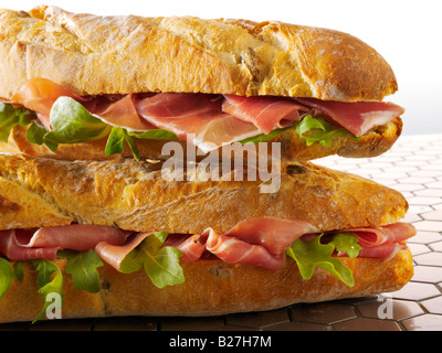 close up of cheese prosciutto and salad baguette in french bread stick Stock Photo