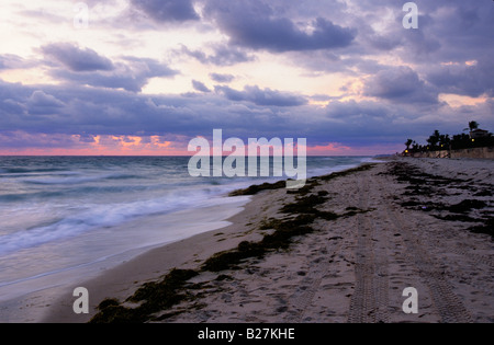 Beach at sunset under a moody cloudy sky on the southeast coast of Florida USA Stock Photo