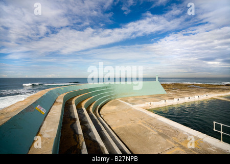 Art Deco style Ocean Baths lido in Newcastle, NSW, Australia. Characteristic breakwater and terraced spectator seating area. Stock Photo