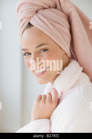 Woman with towel wrapped around hair Stock Photo