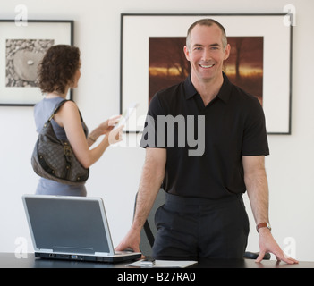 Businessman leaning on desk Stock Photo