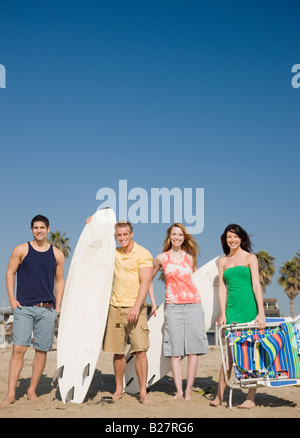 Group of friends standing on beach Stock Photo