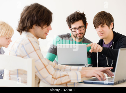 College students with laptops in classroom Stock Photo