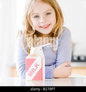 Girl next to carton of milk Stock Photo