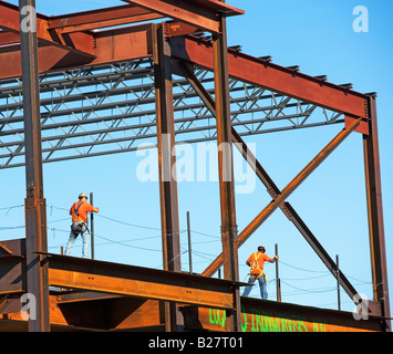Construction workers walking on steel girders, New York City, New York, United States Stock Photo