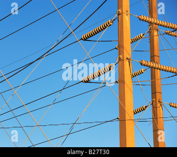 Low angle view of power lines on poles Stock Photo