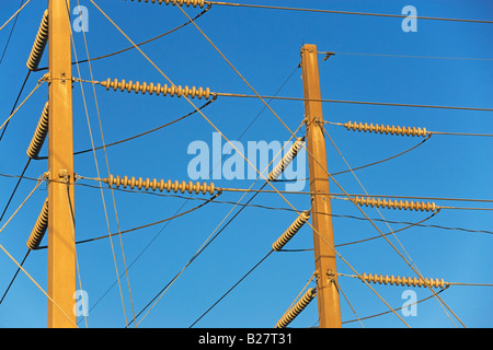 Low angle view of power lines on poles Stock Photo