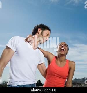 Multi-ethnic couple laughing Stock Photo