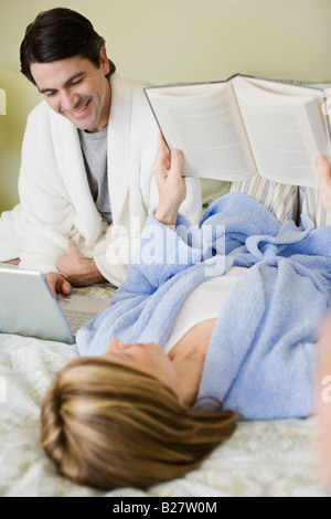 Couple relaxing on bed Stock Photo