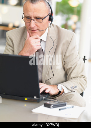 Businessman wearing headset Stock Photo
