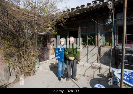 Mr and Mrs Wu in the yard outside their home in the Hutongs area Beijing China Stock Photo