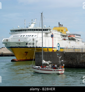 The Cote D albatre ferry in harbour as a yacht makes it way out to sea at Dieppe France Europe Stock Photo