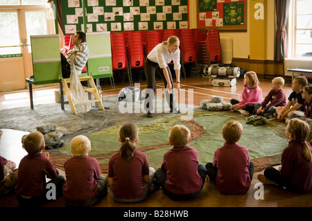Two actors with Theatr Powys performing to young children; theatre in education in primary schools in rural mid wales UK Stock Photo