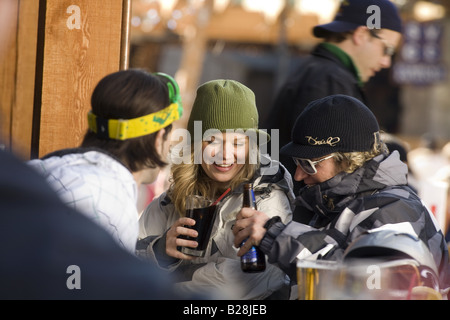 Young Adults enjoy a after ski drink Whislter Village British Columbia Canada Stock Photo