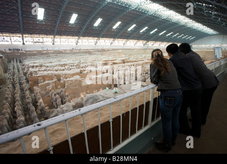 Tourists view infantry figures from the edge of Pit 1 at Qin Museum exhibition halls of Terracotta Warriors China Stock Photo