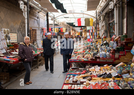 Chinese stall holders selling souvenirs at market in Moslem district of Xian China Stock Photo