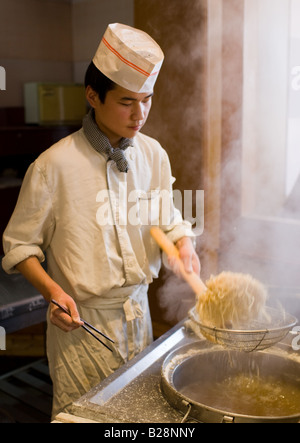 Chef cooking noodles in tourist restaurant Xian China Stock Photo