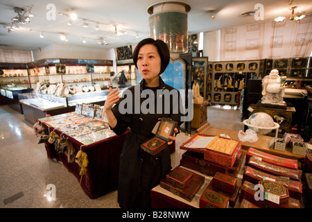 Chinese woman selling Feng Shui compass in gift shop of Shaanxi History Museum Xian China Stock Photo