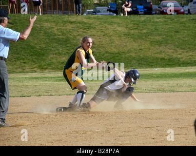 batter being tagged out in high school softball game Stock Photo