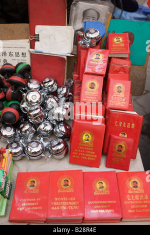 Chairman Mao s Little Red Book and bicycle bells for sale on market stall in Moslem district of Xian China Stock Photo