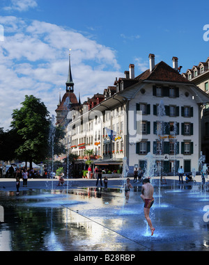Fountain Dancer - panorama of child playing in the water fountain in front of the House of Parliament in Bern, Switzerland Stock Photo