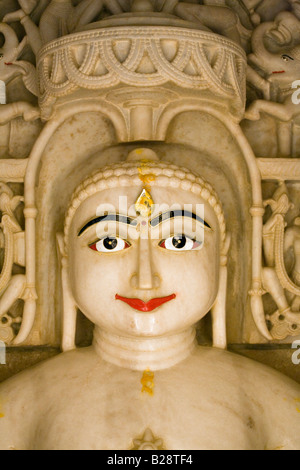A hand carved WHITE MARBLE statue of MAHAVIRA in a JAIN TEMPLE inside JAISALMER FORT RAJASTHAN INDIA Stock Photo