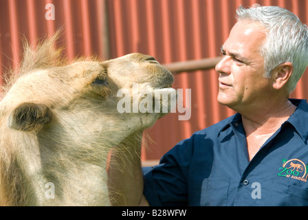 Zoo of Acadiana owner, George Oldenburg, with one year old bactrian camel, Broussard, Louisiana Stock Photo