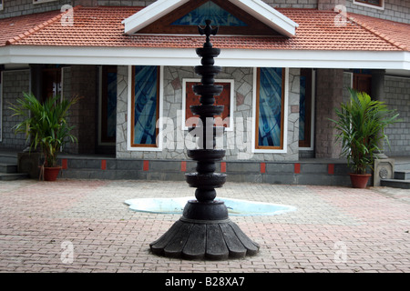 Long black traditional religious lamp on brick patio in front of famous Christian chapel where religious ceremonies take place Stock Photo
