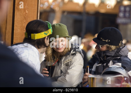 Young Adults enjoy a after ski drink Whislter Village British Columbia Canada Stock Photo