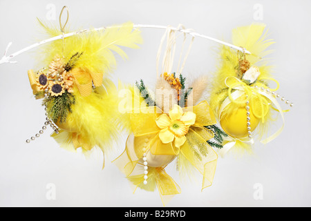 Three Decorative Easter Eggs hanging on white branch Stock Photo