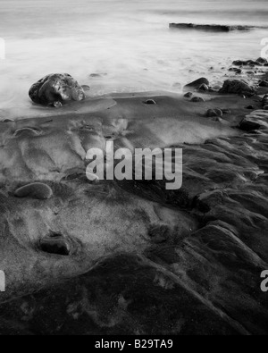 Waves lap the shore on a beach. Stock Photo
