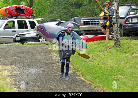 Woman carrying her Canoe down to the waters edge in Ohiopyle Pennsylvania Stock Photo