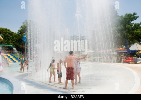 Israel Sfaim water Park summer fun children playing in water jets Stock Photo