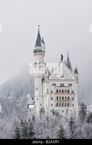 Snow covered mountains surround the famous Neuschwanstein castle, Schwangau, Bavaria, Germany Stock Photo