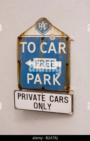 old blue and white rac car parking sign on white wall of building Stock Photo